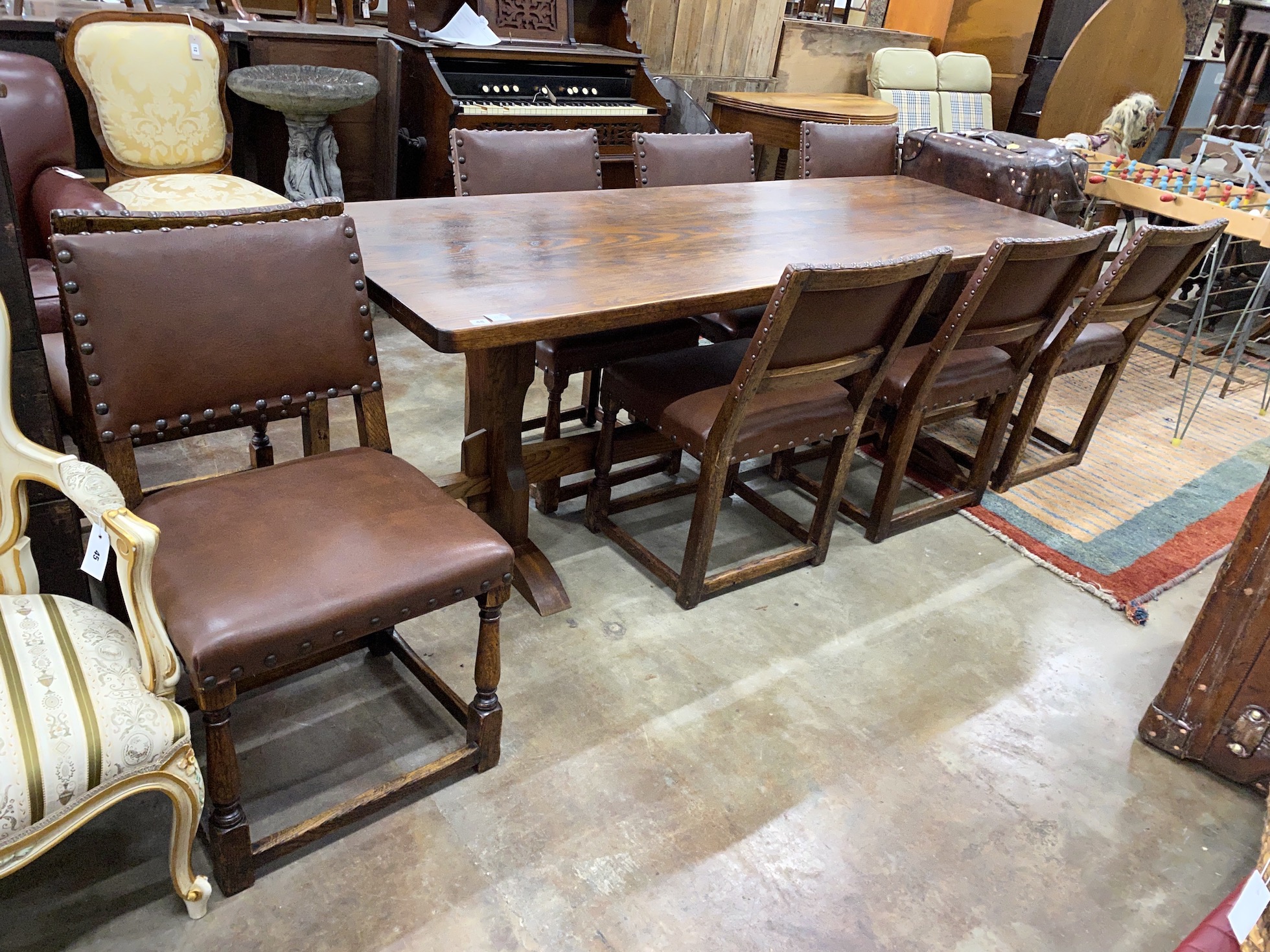An 18th century style rectangular oak refectory dining table, length 214cm, depth 78cm, height 75cm together with a set of eight oak dining chairs